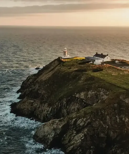 Evening light over the Baily Lighthouse and the rugged coastline at Howth